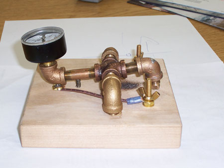 Home brew key made out of 1/8 inch pipe fittings. Tapper a pneumatic air gauge.